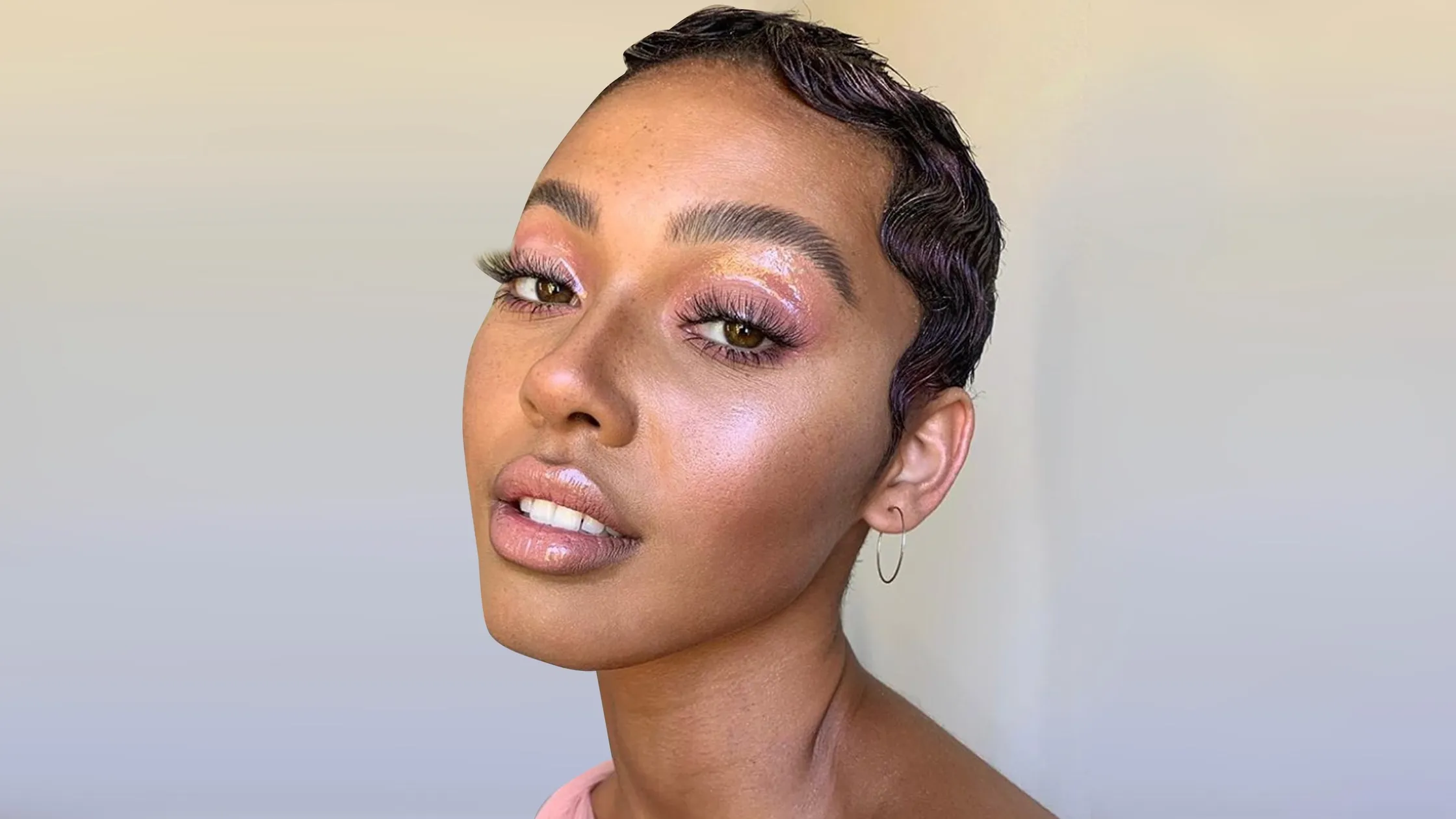 a woman with short hair and pink makeup